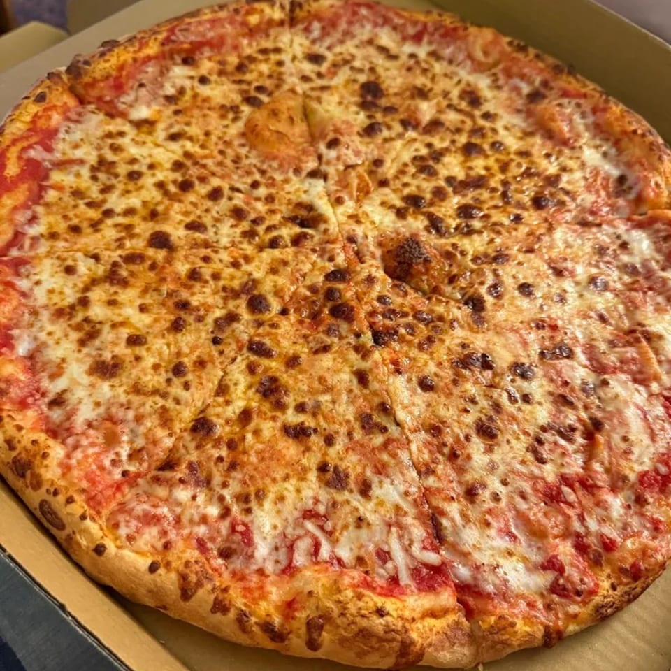 A whole, sliced Brooklyn Pizzeria cheese pizza with a golden crust in a cardboard box.